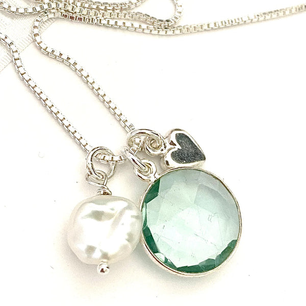 Leoni & Vonk silver and aqua marine necklace on a white background and with a keshi pearl and sterling silver heart charm