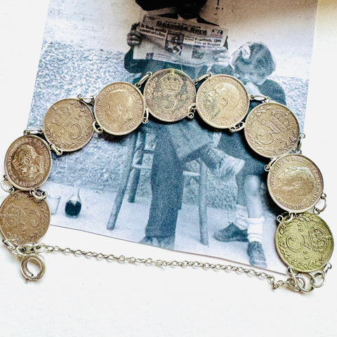 Leoni & Vonk vintage antique silver George V threepence bracelet on a vintage postcard