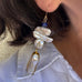 Close up cropped image of leoni & Vonk pearl drop earrings