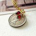 Leoni & Vonk vintage 1964 sixpence necklace on a white background