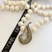 Leoni & Vonk long pearl and vintage marcasite necklace on a white background with Leoni & Vonk ribbon