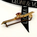 Side view of Leoni & Vonk 9ct gold, red paste stone and seed pearl antique brooch with Leoni & Vonk ribbon