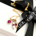 Leoni & Vonk July birthstone charm necklace with pearls and gold bead charm and a ruby heart with Leoni & Vonk ribbon