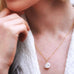 Womens neck with hand up to her chin. She is wearing Leoni & Vonk jewellery keshi pearl neckalce.