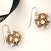 Leoni & Vonk apricot and crystal pearl cluster earrings on a white background and with Leoni & Vonk ribbon.