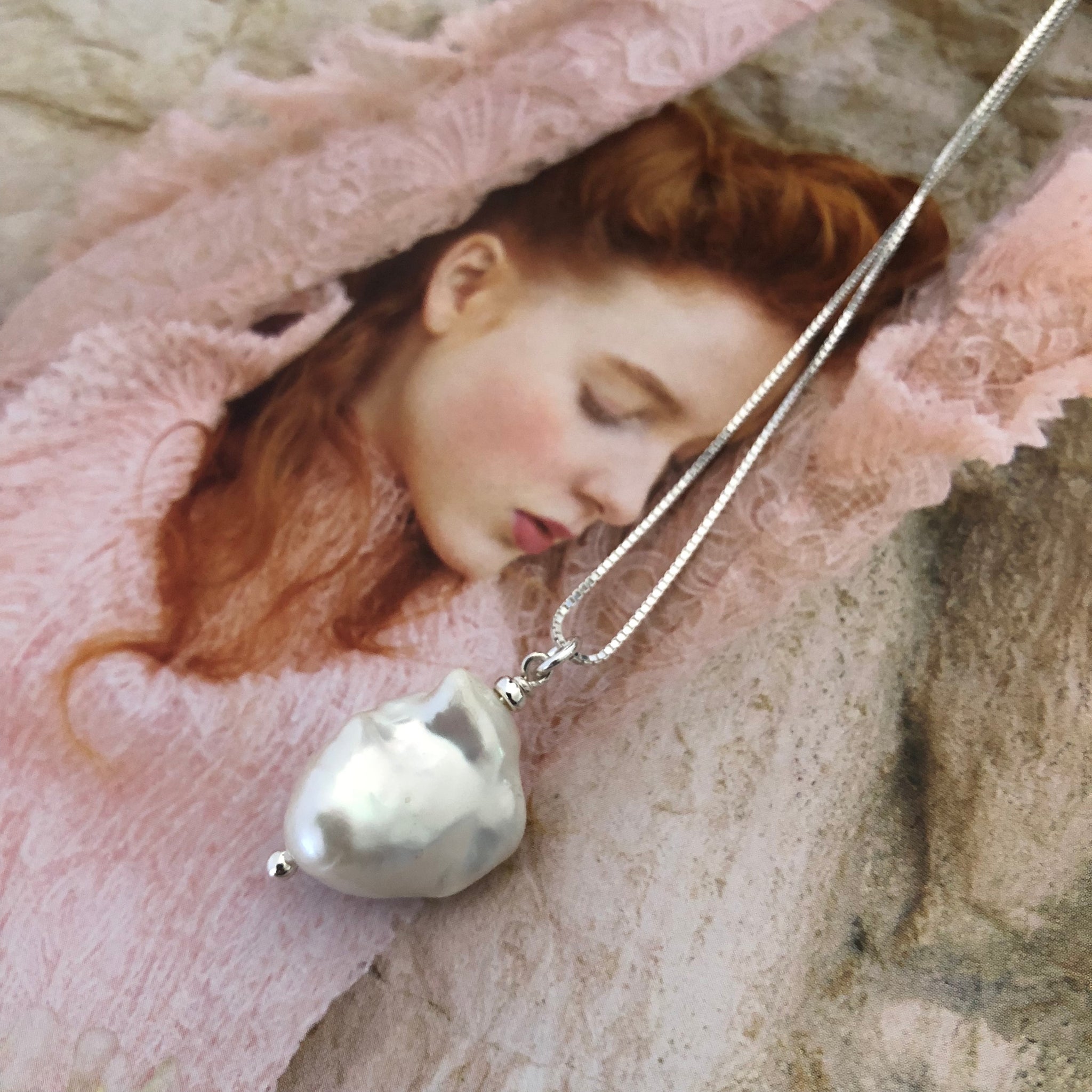 Leoni & Vonk white baroque pearl on sterling silver chain photographed on a magazine page.