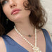Dark haired girl wearing Leoni & Vonk jewellery and a blue dress