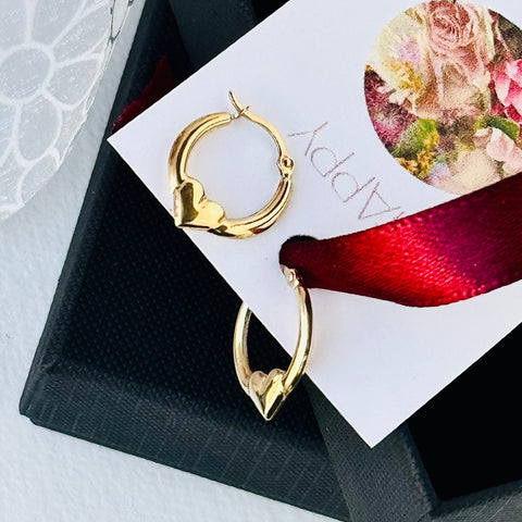 Leoni & Vonk gold heart hoop earrings on a black box and with Leoni  & Vonk Mother's day packaging.
