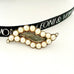 Leoni & Vonk antique eye shaped 9ct gold and pearl mourning brooch on a white background and with Leoni & Vonk ribbon.