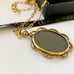 Leoni & Vonk Edwardian rolled gold locket on a gold fill chain on a white background and with Leoni & Vonk ribbon