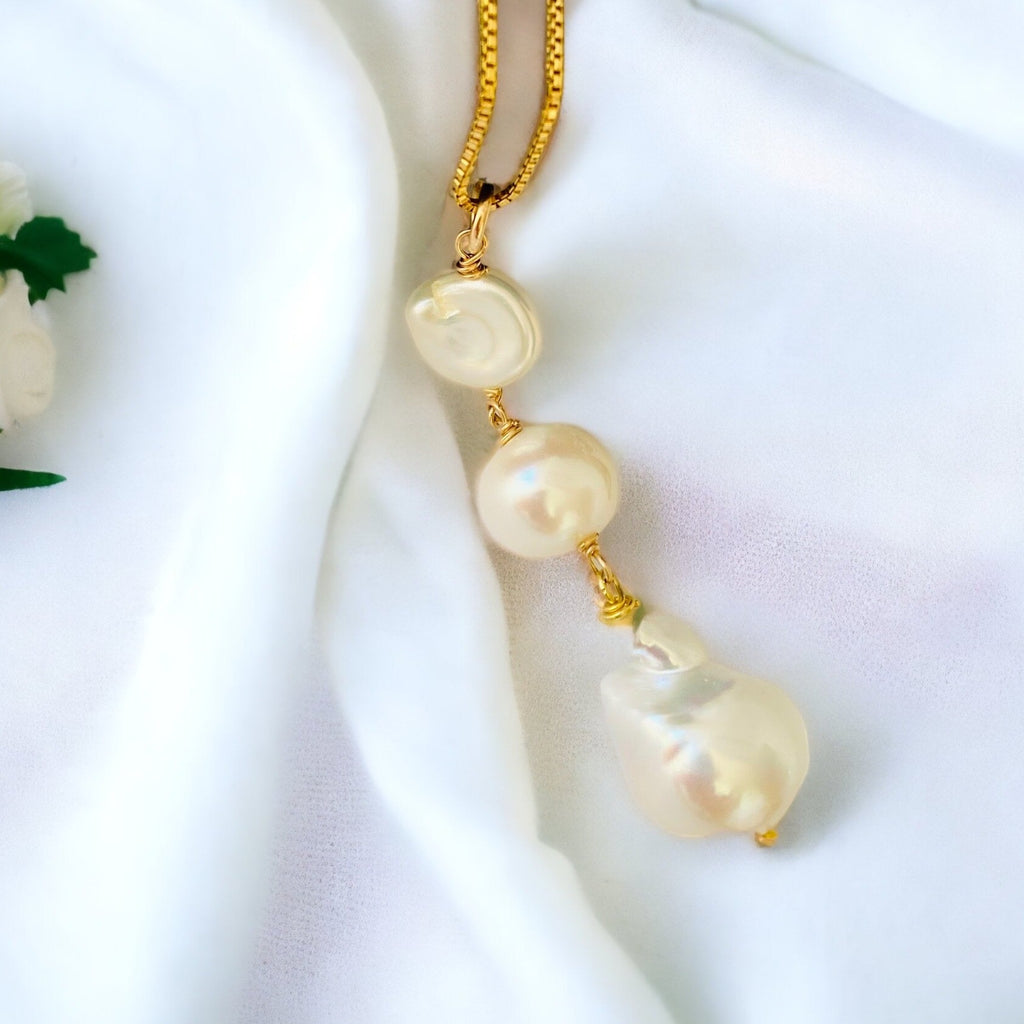 Leoni & Vonk triple drop pearl necklace on white fabric 