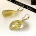 Leoni & Vonk citrine and gold earrings on a white background and with Leoni & Vonk ribbon