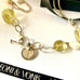Leoni & Vonk citrine and pearl necklace with 1916 threepence on a white background and with Leoni & Vonk ribbon and box 