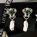 Leoni & Vonk vintage green crystal and pearl earrings on a white background and with Leoni & Vonk ribbon