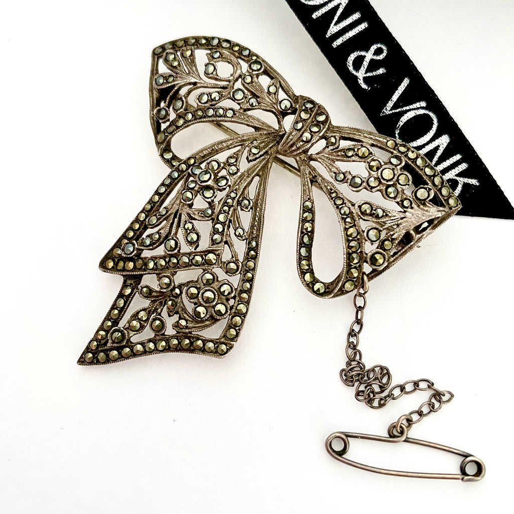Leoni & Vonk sterling silver and marcasite bow brooch on a white background and with Leoni & Vonk ribbon.
