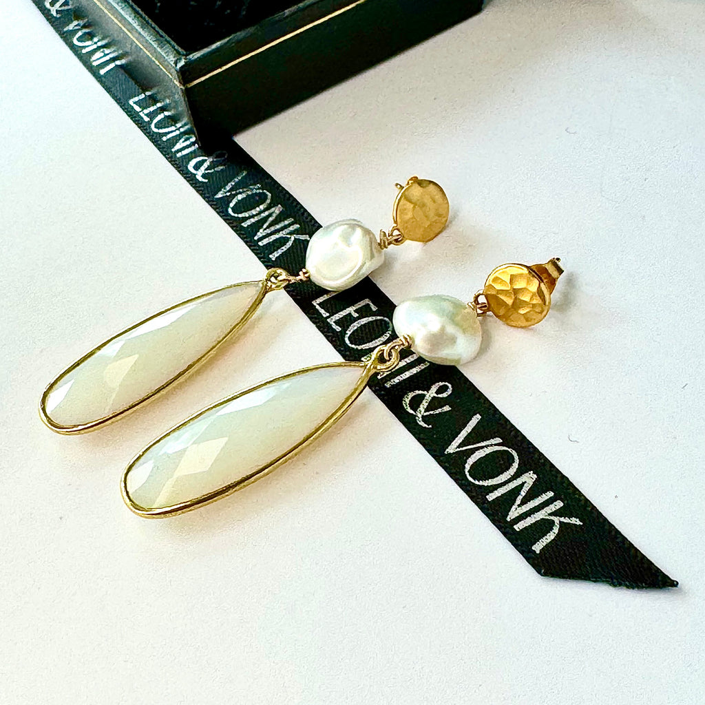 Leoni & Vonk opalite, keshi pearl gold stud earrings ona white background and with Leoni & Vonk ribbon