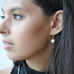 Model wearing Leoni & Vonk gold and pearl ear wire earrings