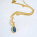 Leoni & Vonk gold and sapphire drop necklace on a white background.