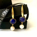 Leoni & Vonk gold plated sapphire and pearl earrings for September birthstone on a white background.