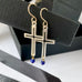 Leoni & Vonk sterling silver cross earrings on a white background with Leoni & Vonk ribbon