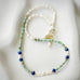 Leoni & Vonk turquoise and lapis neckalce on a white textured plate