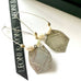 Leoni & Vonk vintage Stokes sterling silver medallion earrings on a white background and with Leoni & Vonk ribbon.