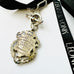 Back ofLeoni & Vonk William hair Hasler antique watch fob neckalce on a white background and with Leoni & Vonk ribbon