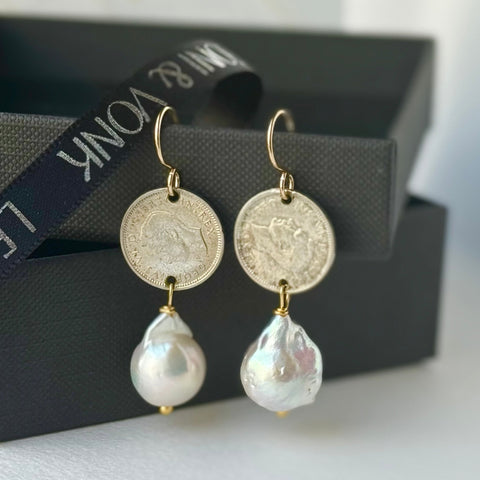 Leoni & Vonk George IV threepence and baroque pearl earrings on a balck box and with Leoni & Vonk ribbon