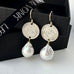 Leoni & Vonk George IV threepence and baroque pearl earrings on a balck box and with Leoni & Vonk ribbon