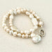 Leoni & Vonk luxe pearl necklace with sterling silver clasp on a white textured background