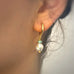 Cropped image showing a girls ear wearing Leoni & Vonk pearl earrings