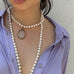 Cropped image of dark haired girl wearing Leoni & Vonk antique jewellery