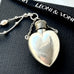 Leoni & Vonk antique sterling silver heart shaped perfume bottle on a black box and with Leoni & Vonk ribbon