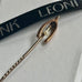 Leoni & Vonk antique wishbone stick pin with pearl  on a white background and with Leoni & Vonk ribbon