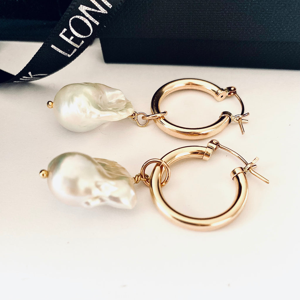 Leoni & Vonk gold hoop and large white baroque pearl earrings on a white background and with Leoni & Vonk box and ribbon