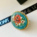 Leoni & Vonk vintage micro mosaic brooch on a white background with Leoni & Vonk ribbon
