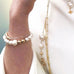 Image of a woman's fore arm. She is wearing Leoni & Vonk pearl jewellery.