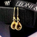 Leoni & Vonk natural citrine drop earrings on a black box and with Leoni & Vonk ribbon