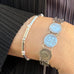Cropped image of a womans wrist wearing Leoni & Vonk bracelets.
