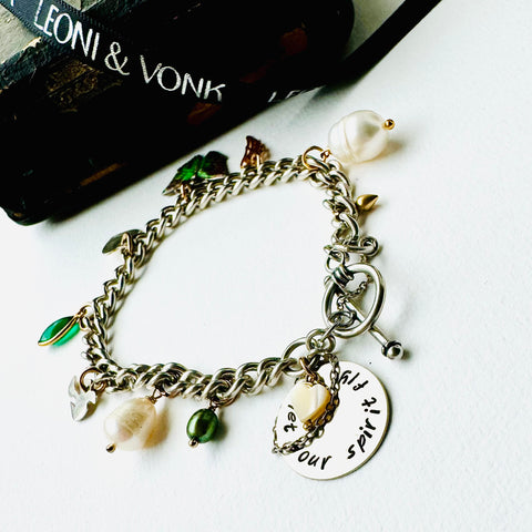 Leoni & Vonk sterling sivler charm bracelet with pearl, butterfly, heart, bird and Let Your Spirit Fly disc on a white background