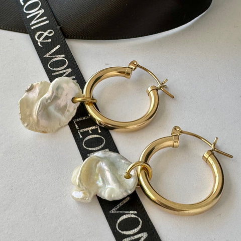 Leoni & Vonk gold hoop earrings with keshi pearl drops on a white background and with Leoni & Vonk ribbon