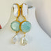 Leoni & Vonk agate and pearl drop earrings on a white background