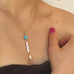 Cropped image of a girls neck wearing Leoni & Vonk pearl and howlite necklace