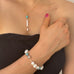 Cropped image of a girls neck wearing Leoni & Vonk pearl and howlite necklace and bracelet