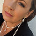 Dark haired woman wearing leoni & Vonk pearl jewellery