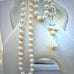 Leoni & Vonk long pearl necklace on a white vase