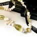 Leoni & Vonk pearl and citrine necklace on a white background and with Leoni & Vonk ribbon and box