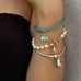Cropped image of a womans's arm wearing Leoni & Vonk bracelets.