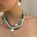 Cropped image of a girl wearing Leoni & Vonk pearl jewellery. You can only see her neck