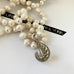 Leoni & Vonk long pearl and vintage marcasite necklace on a white background with Leoni & Vonk ribbon